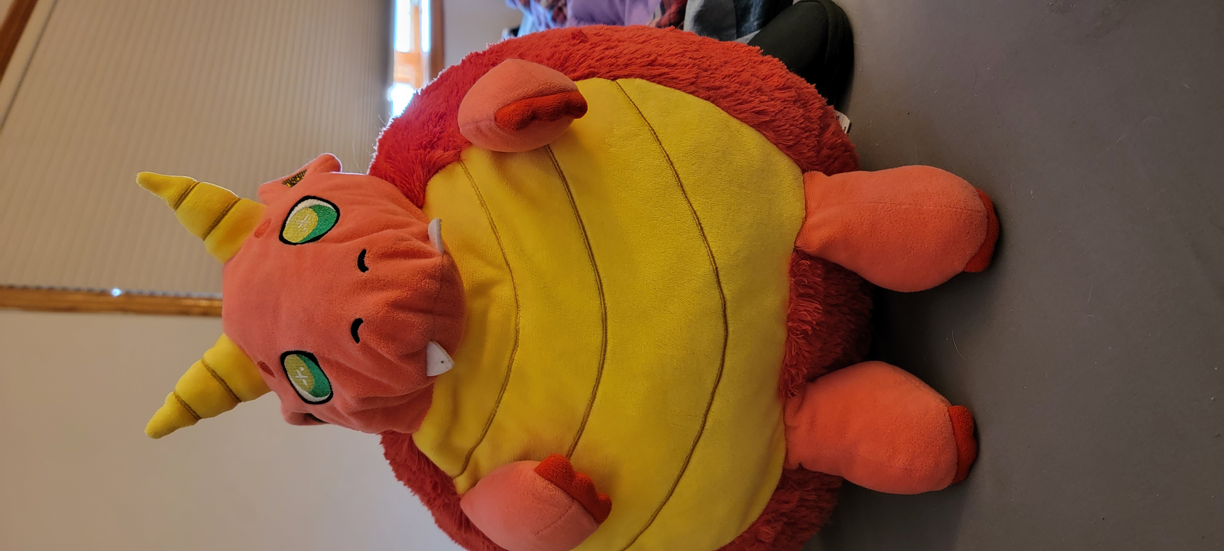 Fat Dragon, K.P. Aubrys's emotional support stuffed dragon